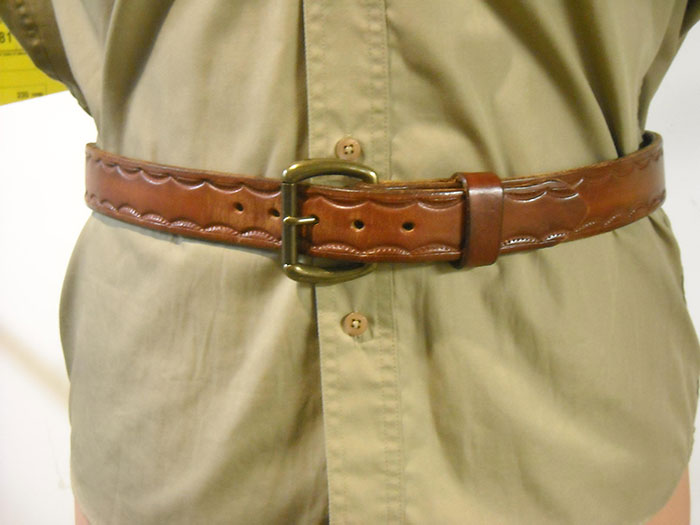 A STAMPED BELT ON A MANNEKIN